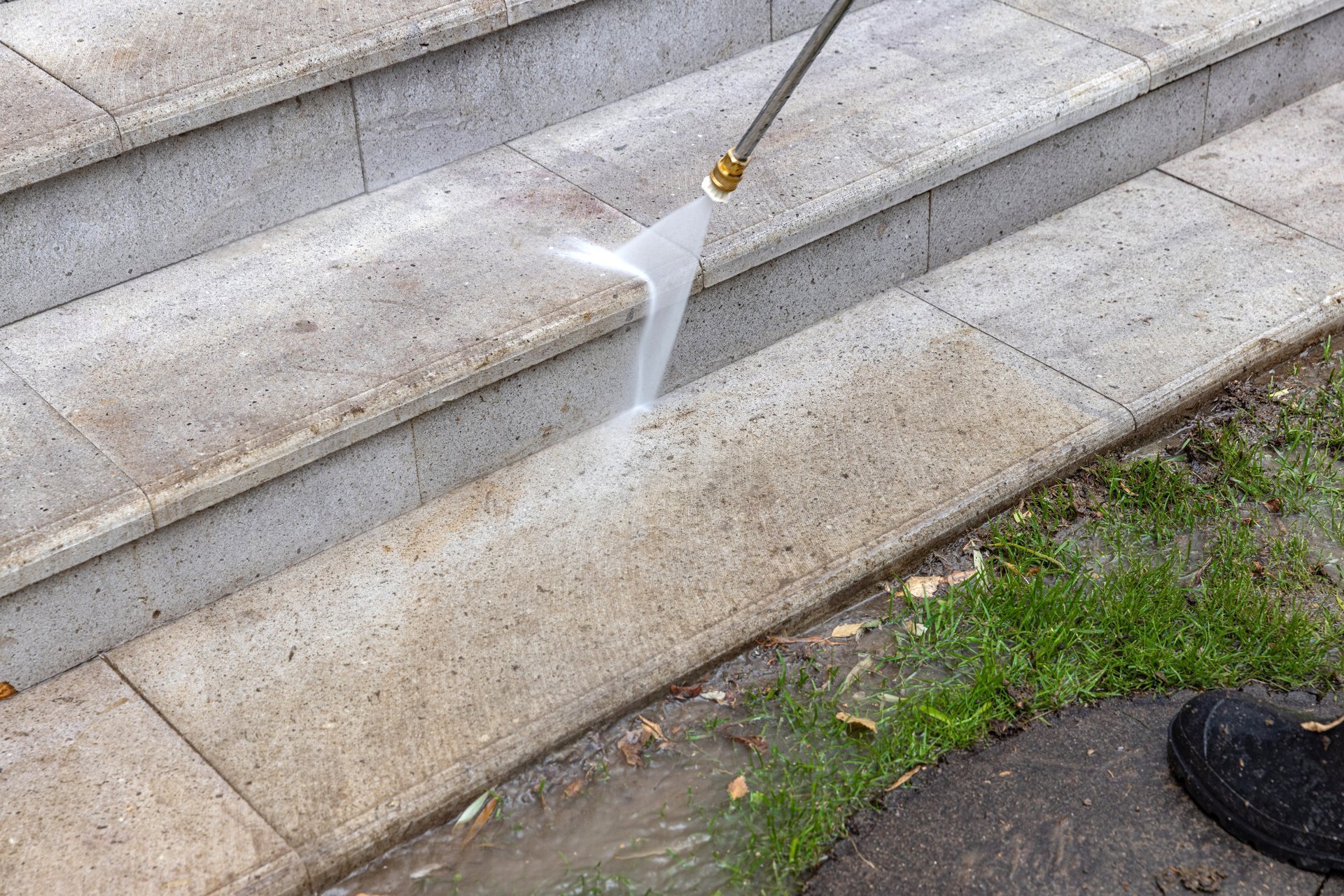Outdoor cleaning service washing stone stairs with high pressure water